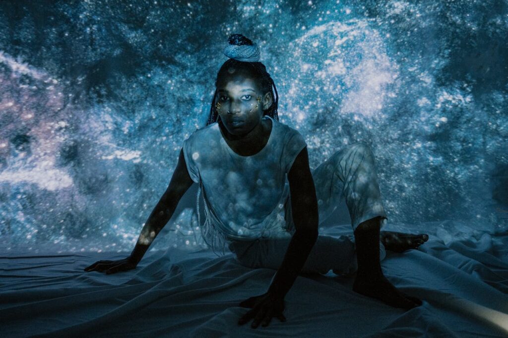 Creative portrait of a woman with galaxy projections, evoking a cosmic ambiance.